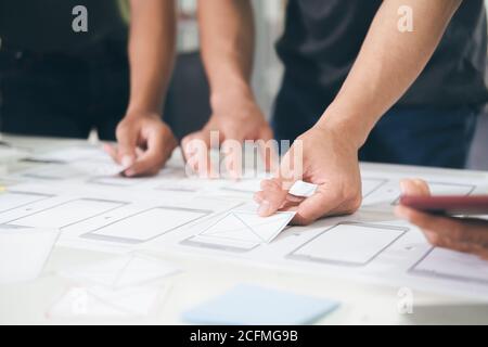 Programmer and UX UI designer working in a software development and coding technologies. Mobile and website design and programing development technolo Stock Photo