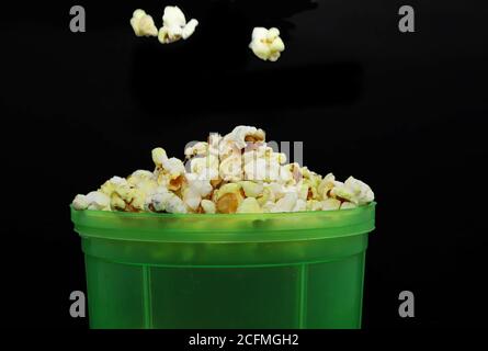 Popcorn. Flat lay of popcorn cup on a black backgrounds. Stock Photo