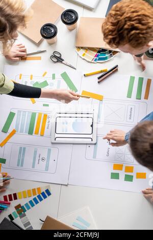 Top view of several creative professional developers discussing sketches Stock Photo