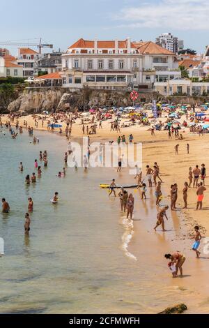 Beach full of locals and tourists on a sunny summer weekend in Cascais, near Lisbon, Portugal Stock Photo