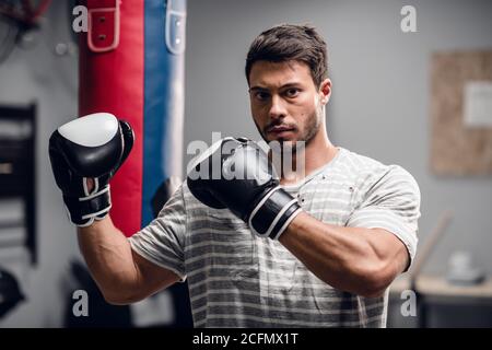an athlete boxer poses for a photo session in the hall where he is engaged Stock Photo