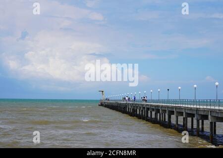 The lover's bridge is a concrete pier that leads far out to sea, with a jetty at the end that allows fishing boats to dock at Tanjung Sepat. Stock Photo