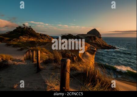 Beautiful sunset shining on red rocks of Cape Kiwanda Stock Photo