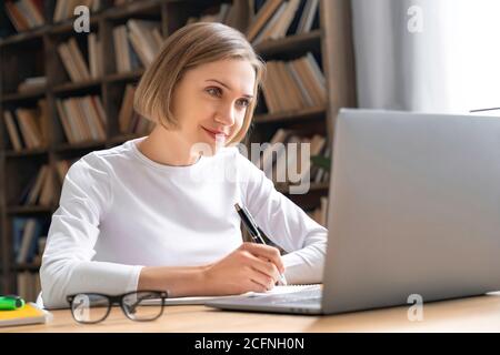 Female student enjoy e-learning. Stock Photo