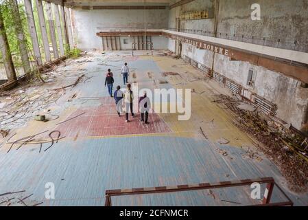 Pripyat / Ukraine - May 15, 2018: group of tourists visiting gym on tour of Chernobyl in Pripyat Stock Photo