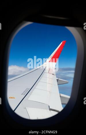 View from airplane porthole on passenger seat Stock Photo