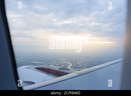 Sunrise view from airplane window on passenger seat Stock Photo