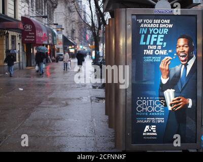 Manhattan, New York, NY, USA - An outdoor billboard at a bus stop. Ordinary scene of the street in the Upper West Side area. Rainy day in the winter. Stock Photo