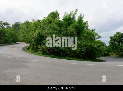 Winding paved road in Thailand Stock Photo