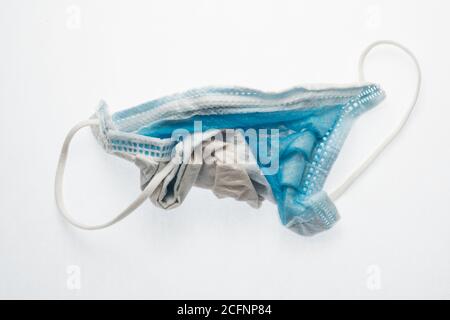 A discarded and used surgical face mask, a increasingly common piece of litter during the Covid 19 pandemic. Stock Photo
