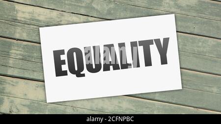 Equality word on card on grunge wooden background. social diversity Concept. Stock Photo