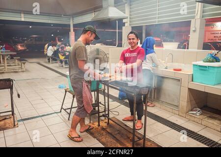 Bandar Seri Begawan / Brunei - January 16, 2019: man cooking food at Gadong Night Market Stock Photo