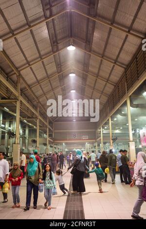 Bandar Seri Begawan / Brunei - January 16, 2019: crowd of people looking for food at Gadong Night Market with smoky ambience Stock Photo