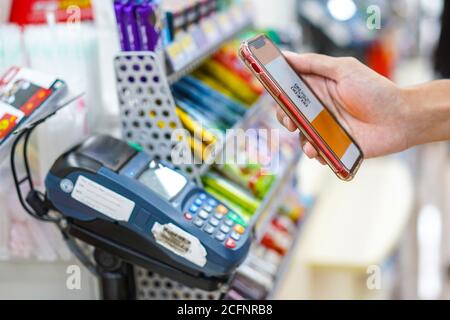 Hand of man making a contactless payment using a smartphone Stock Photo