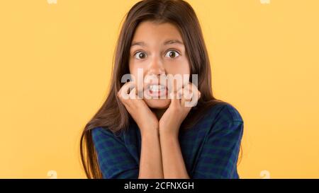 Surprised shocked little girl looking at camera Stock Photo