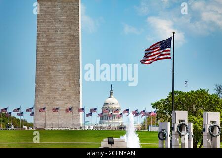WWII and Washington memorial obelisk column over flags, US Capitol building, DC, USA Stock Photo