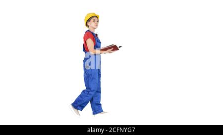 Female engineer in yellow safety helmet checking documentation with what is built on white background. Stock Photo
