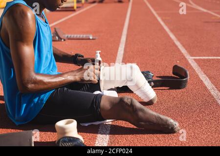 Male athlete wearing prosthetic leg on race track Stock Photo