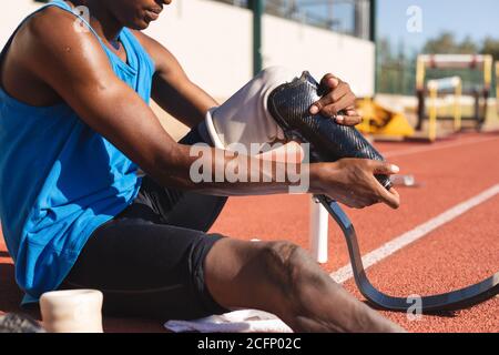 Male athlete wearing prosthetic leg on race track Stock Photo
