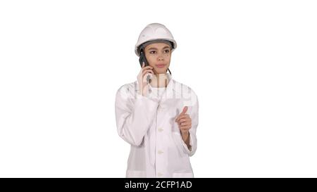 Woman engineer talking on the phone while walking on white background. Stock Photo