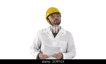 Site engineer cheching papers and something around him on white background. Stock Photo