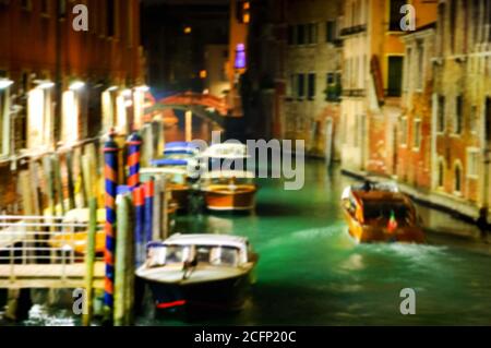 Blurry photo of small canal at night. Venice (Italy) Stock Photo