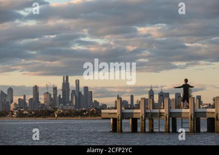 Melbourne Australia. Scenes of daily life. Working out on a pier on Port Phillip Bay with the Melbourne skyline in the background . Stock Photo