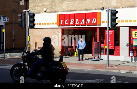 Shopper outside Iceland frozen food store in Driffield, East Yorkshire, England UK Stock Photo