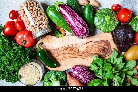 Cooking healthy food background. Raw fresh vegetables, legumes, cereals, top view. Zero waste, vegan food, eco friendly concept. Stock Photo