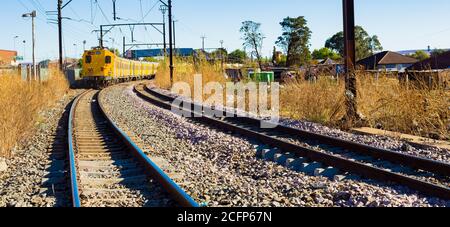 Soweto, South Africa - September 08 2018: Commuter Train moving through the heart of Soweto, Johannesburg Stock Photo