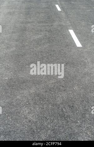 Dark Gray Asphalt with White Road Marking Lines. Abstract background. Copspace Stock Photo