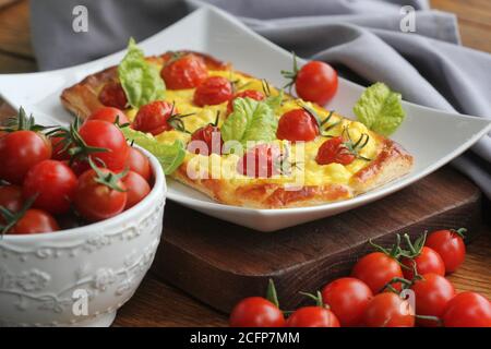 Fresh tomato tart, puff pastry topped with ricotta, cheese and cherry tomatoes Stock Photo