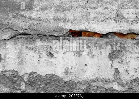Old shabby cracked cement wall covering brickwork with red bricks. Abstract background with color contrast Stock Photo