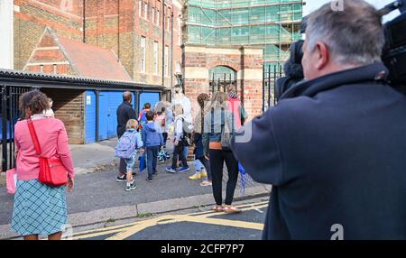 Brighton UK 7th September 2020 - Pupils and parents outside St Luke's Primary School in Brighton this morning where the road has been closed to help with social distancing and road safety on their return to education . The new School Street scheme has been introduced to fourteen schools by the city council for the start of term in September and is enforced twice a day for an hour between 8-10am and 2-4 pm : Credit Simon Dack / Alamy Live News Stock Photo