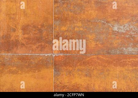 Rusty background texture with seams. Tiled stained rusty wall Stock Photo