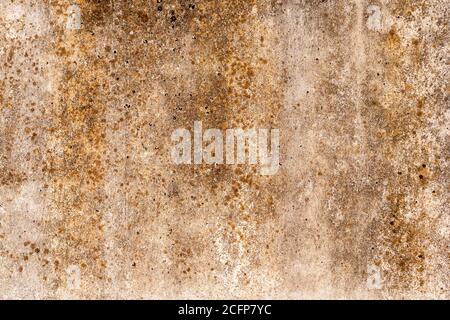 Vintage grunge background with shades of rust on the old concrete wall, cracks and textures of golden brown stains Stock Photo
