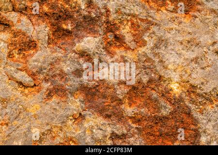 Grungy bright stone close up, rusty stone wall corrosion texture for web design and wallpaper background Stock Photo