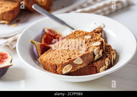 Portion of walnut-fruit cake with yogurt and figs. Stock Photo
