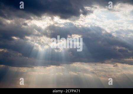 Cloudy blue sky with sunrays Stock Photo