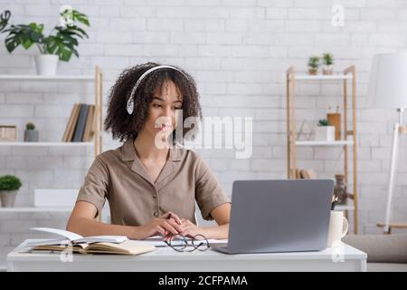 Young student watching lesson online and studying from home Stock Photo