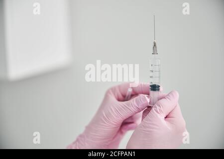 Doctor in latex gloves preparing for injecting a medicine Stock Photo