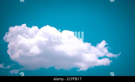 Heart shaped gate decorate with purple p A single fluffy white cloud against a blue sky ink and green bougainvillea Stock Photo
