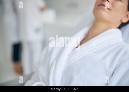 Relaxed female patient dressed in a bathrobe Stock Photo