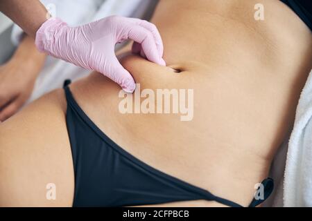 Professional dermatologist examining an adult Caucasian woman Stock Photo