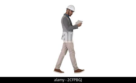 Engineer walking and working on digital tablet on white background. Stock Photo