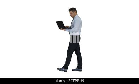 Formal man walking and using laptop on white background. Stock Photo