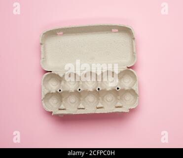 blank paper rectangular tray for chicken eggs on pink background, top view Stock Photo