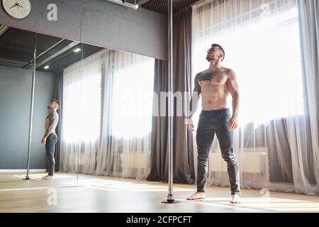 Trainer of pole dance standing in the fitness class Stock Photo