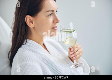 Dreamy spa client dressed in a waffle weave bathrobe Stock Photo