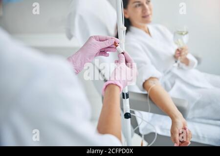 Nurse in latex gloves performing a medical procedure Stock Photo